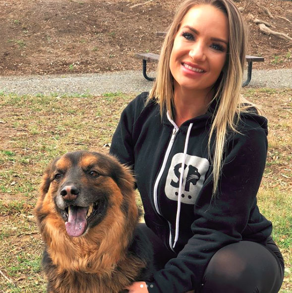 Cali Carter posing with her dog